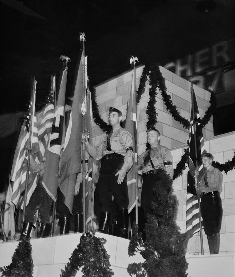 German-American Bund members stand near the Nazi Germany flag and the American flag during a rally at Madison Square Garden.