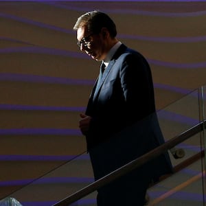 Serbia's President Aleksandr Vucic walks down stairs.