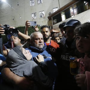 Al Jazeera reporter Wael al-Dahdouh surrounded by a crowd in Gaza.