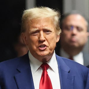 Former US President Donald Trump speaks to the press in a hallway outside the courtroom in a hearing to determine the date of his trial for allegedly covering up hush money payments, at Manhattan Criminal Court in New York City on March 25, 2024