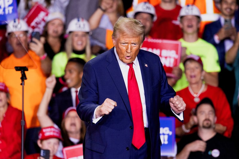 Republican presidential nominee and former U.S. President Donald Trump dances at a campaign rally in Grand Rapids, Michigan, U.S., November 5, 2024.  REUTERS/Carlos Osorio