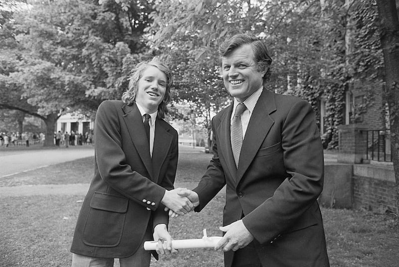 Sen. Edward M. Kennedy, left, congratulates his nephew, David Kennedy, right after a graduation ceremony.