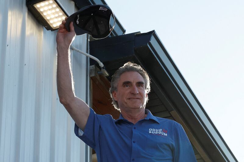 Republican U.S. presidential candidate and North Dakota Governor Doug Burgum waves as he participates in a Fair-Side Chat with Governor of Iowa Kim Reynolds