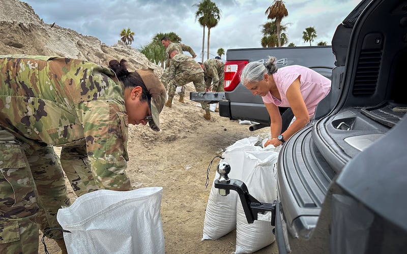 U.S. Air Force airmen fill sandbags.