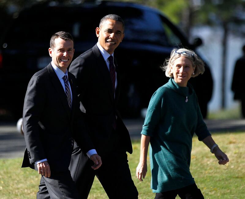 David Plouffe walks alongside Barack Obama.