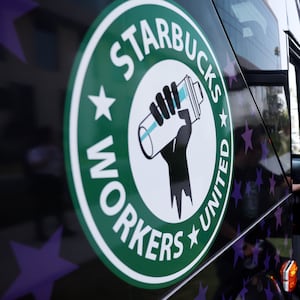 A Starbucks worker boards the Starbucks union bus after Starbucks workers stood on the picket line.