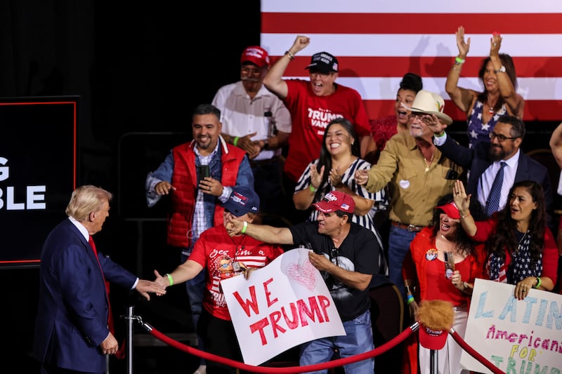 Trump greets a group of supporters before holding a rally in Arizona.