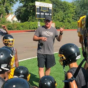 Tim Walz, then a candidate for Minnesota governor, gives a pep talk to football players at Como Park Senior High School in St. Paul in 2018. 