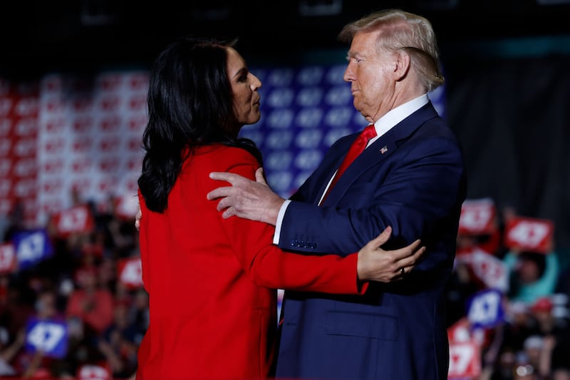 Former U.S. Representative from Hawaii Tulsi Gabbard and Republican presidential nominee, former U.S. President Donald Trump embrace during a campaign rally at the Greensboro Coliseum on Oct. 22, 2024, in Greensboro, North Carolina.