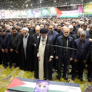 Iran's Supreme Leader Ayatollah Ali Khamenei among a crowd of nearly 10,000 people, performs prayer at the funeral of assassinated Hamas chief, Ismail Haniyeh.