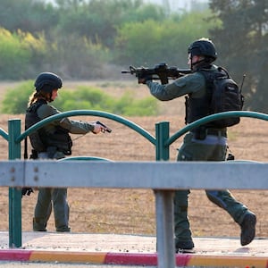 Members of the Israeli security forces secure an area near a checkpoint on the outskirts of Sderot after an attack by Hamas militants.