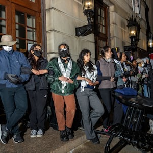 Demonstrators link arms to protect their fellow protestors barricaded inside Hamilton Hall from authorities as members of the NYPD surround the Columbia University campus to clear the pro-Palestinian protest encampment on April 30, 2024 in New York City.