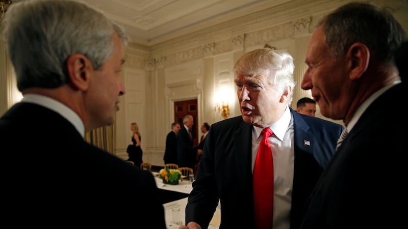 Donald Trump and Jamie Dimon shake hands.