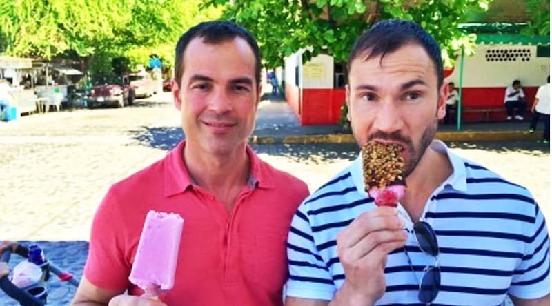 Devon, left, holds an ice cream while posing next to his friend