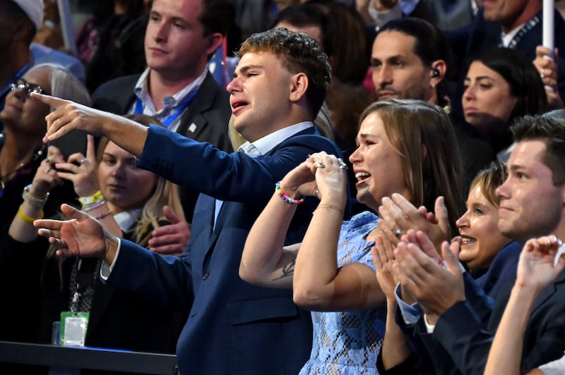 Minnesota Governor and 2024 Democratic vice presidential candidate Tim Walz's son Gus (L) and daughter Hope (2nd L) react .