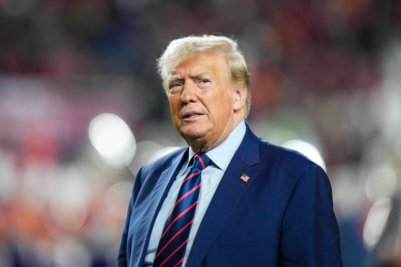 Former President Donald Trump looks on at half time of a game between the South Carolina Gamecocks and the Clemson Tigers.