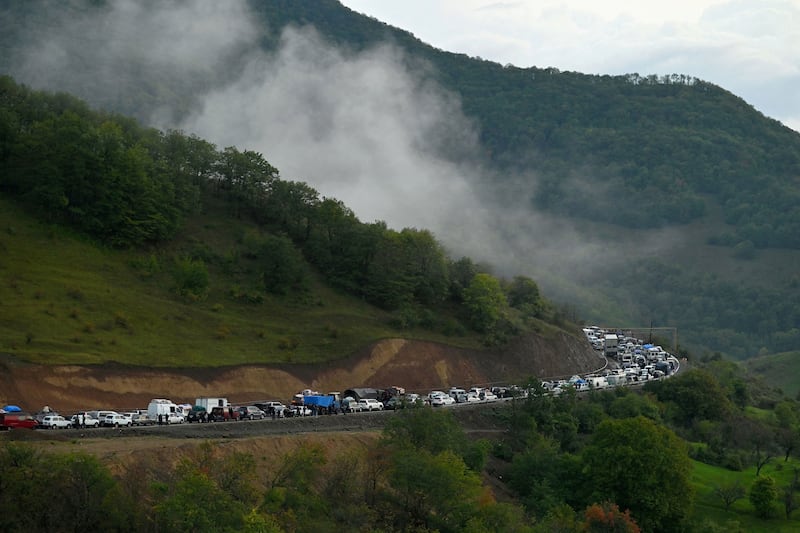 A photograph of vehicles carrying refugees from Nagorno-Karabakh waiting to cross the Armenian border, in Nagorno-Karabakh, September 25, 2023.