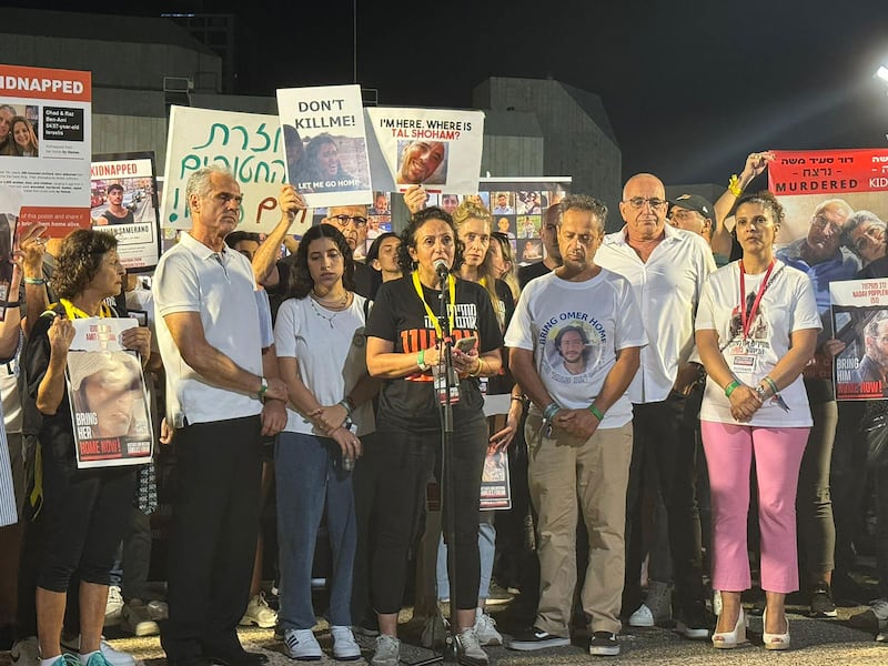 A picture of Meirav Leshem Gonen in front of a large crowd at a press conference