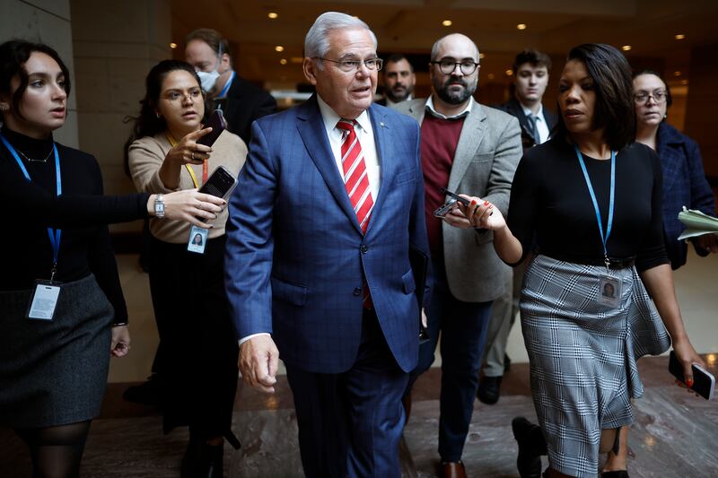 A photo including Senator Bob Menendez talking to Journalists at the U.S Capitol