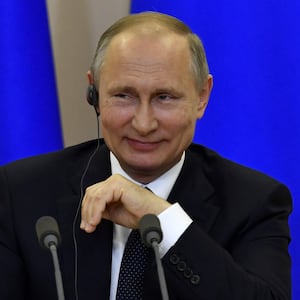 Vladimir Putin smiles during a joint press conference with Italian Prime Minister Paolo Gentiloni following their meeting at the Bocharov Ruchei state residence in Sochi, Russia, May 17, 2017. 