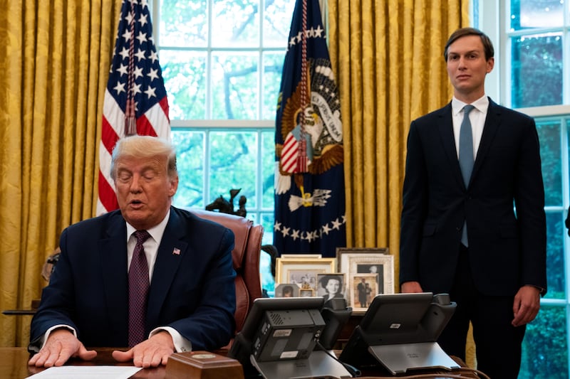 Former advisor Jared Kushner looks on as his father-in-law, former president Donald Trump, speaks in the Oval Office.