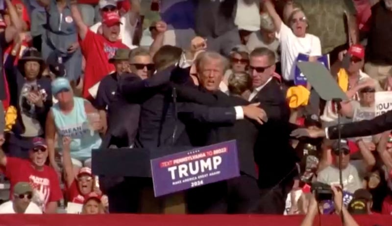 Republican presidential candidate and former U.S. President Donald Trump is assisted by security personnel after gunfire rang out during a campaign rally at the Butler Farm Show in Butler, Pennsylvania, U.S., July 13, 2024.