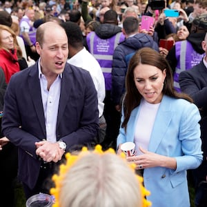 The Prince and Princess of Wales speak with the public during an event.