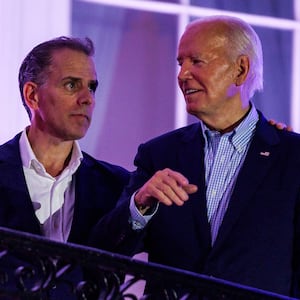 President Joe Biden talks to his son, Hunter Biden, on the White House balcony during a 4th of July event on the South Lawn of the White House on July 4, 2024 in Washington, DC.