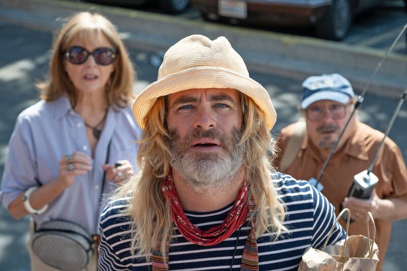 Anette Benning, Chris Pine, and Danny DeVito stare into the camera in a still from ‘Poolman’