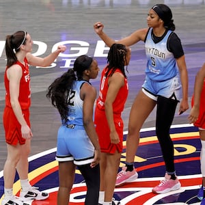 Chicago Sky forward Angel Reese (5) and Indiana Fever guard Caitlin Clark (22) fist bump before the opening jump ball