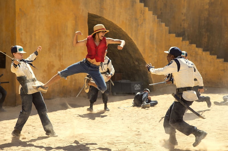 Iñaki Godoy as Monkey D. Luffy in One Piece flies through the air mid-punch while he fights off soldiers