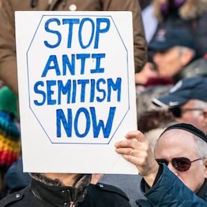 Photograph showing a support sign reading “stop antisemitism now”