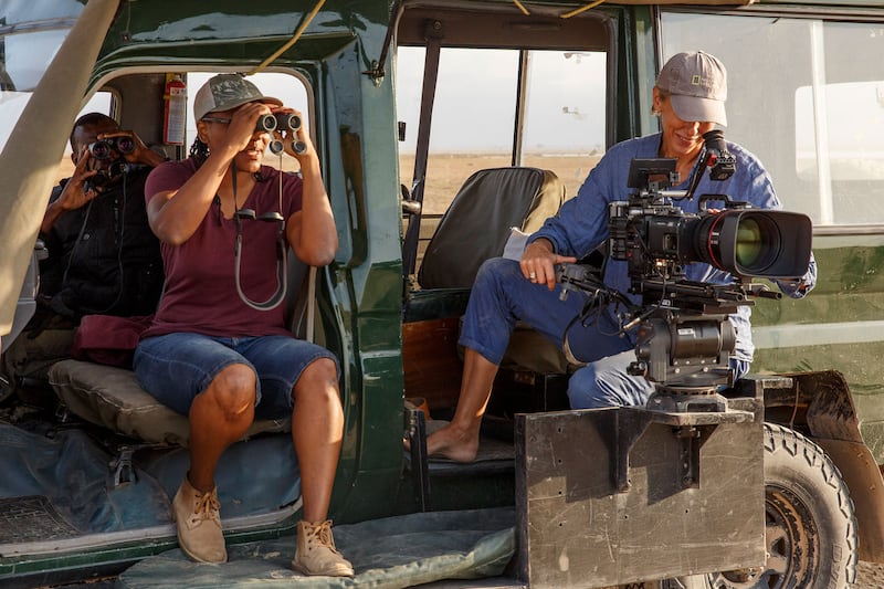 Photo of Queens director Faith Musembi and director of photography Sophie Darlington film elephants from the vehicle. 