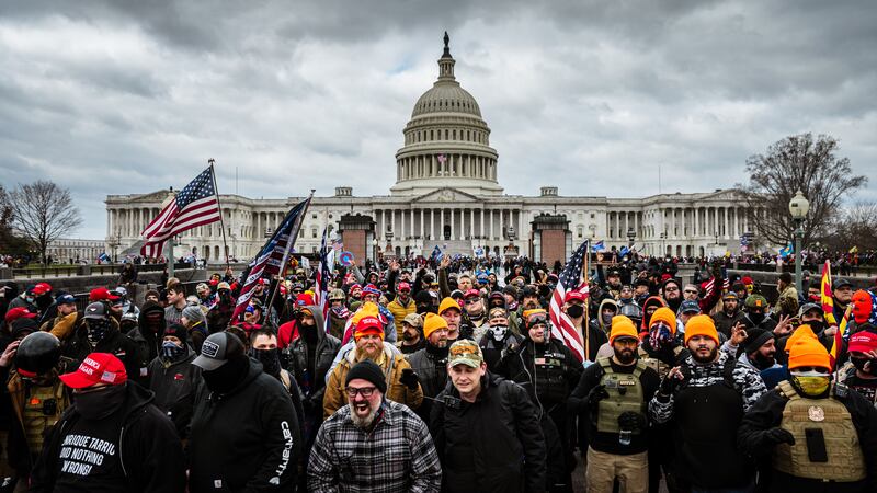 A photo including Pro-Trump protesters gathered in front of the U.S. Capitol Building