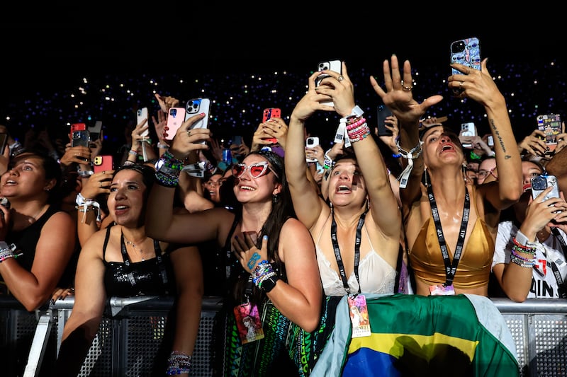 Taylor Swift’s fans react during the sweltering concert in Rio