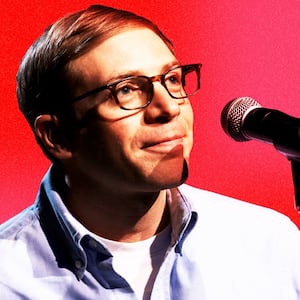 Photograph of Joe Pera on a pink and red background