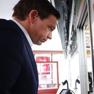 Ron DeSantis stares forward while ordering food in New Hampshire.