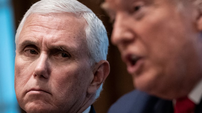 Former Vice President Mike Pence looks on at Donald Trump