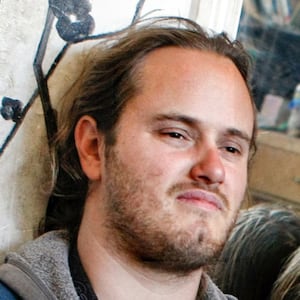 David Depape, with long hair and a beard, stares forward in a 2013 photo. 