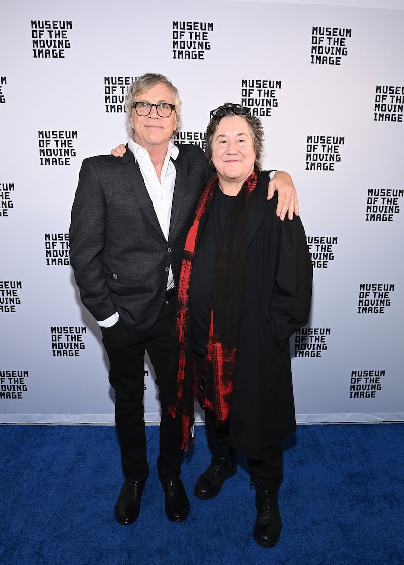 A picture of Todd Haynes and Christine Vachon posing in front of a step and repeat.