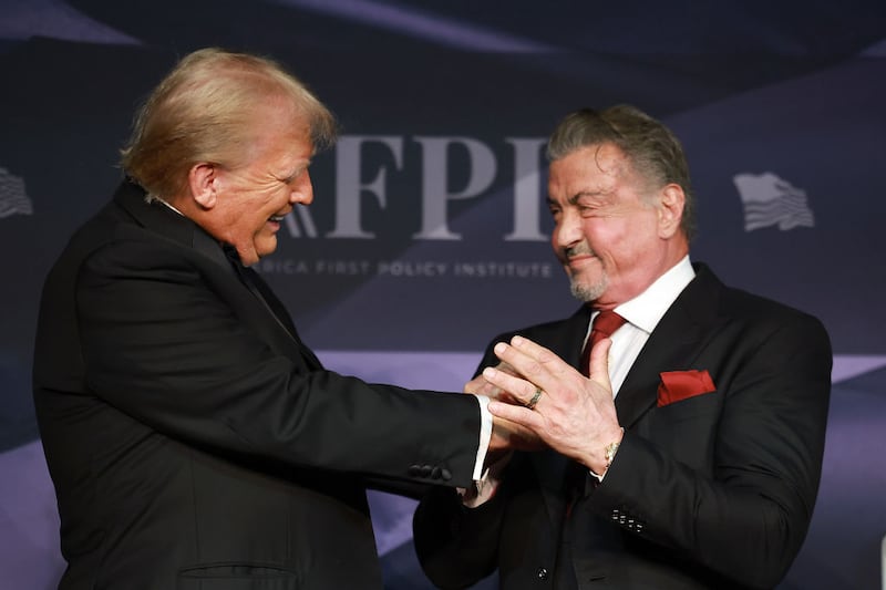 U.S. President-elect Donald Trump greets actor Sylvester Stallone onstage at the America First Policy Institute Gala held at Mar-a-Lago on November 14, 2024 in Palm Beach, Florida. The annual event supports Grey Team, a nonprofit organization dedicated to preventing military suicide.