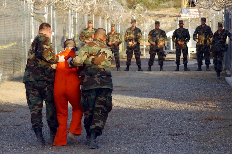 articles/2014/03/14/ex-cia-top-lawyer-release-the-black-site-report/140313-gitmo-torture-lake-tease_zh2mdg