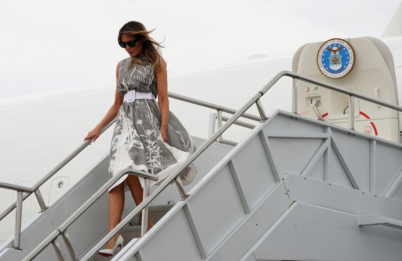 Melania Trump exits Air Force One in a dress.