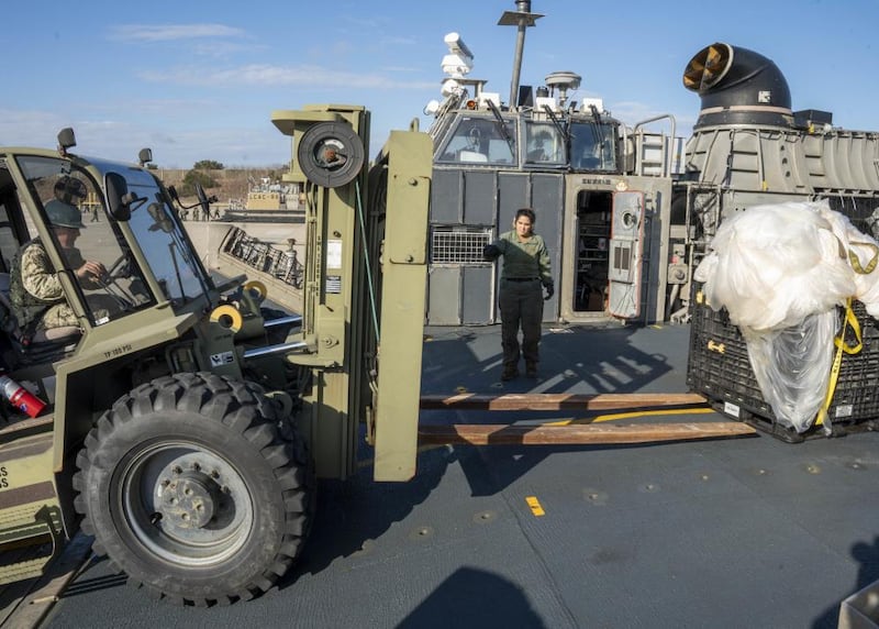 U.S. Navy personnel on Friday securing and transporting the remnants of a Chinese spy balloon