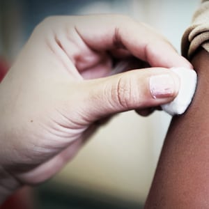 image of child getting a shot with bandage over arm afm acute flaccid myelitis polio like minnesota cdc enterovirus d68 mysterious mystery disease kids children