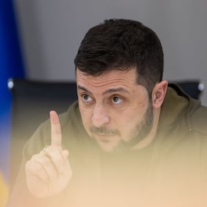 Ukraine's President Volodymyr Zelensky raises finger while talking.