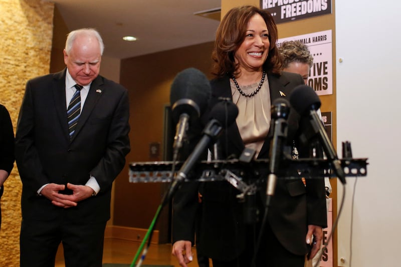 U.S. Vice President Kamala Harris speaks next to Minnesota Governor Tim Walz during a visit to the St. Paul Health Center, a clinic that performs abortions, in St. Paul, Minnesota, U.S., March 14, 2024.