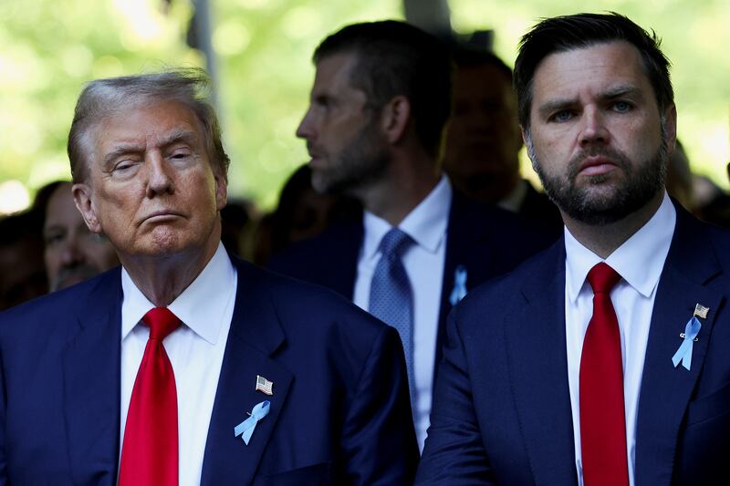 Donald Trump and J.D. Vance stand next to each other in matching outfits.