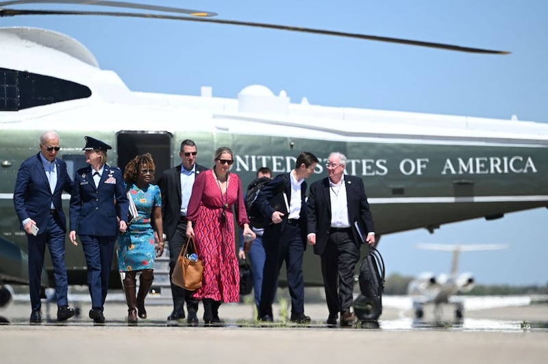 President Joe Biden walks with aides before boarding Air Force One at Joint Base Andrews in Maryland.