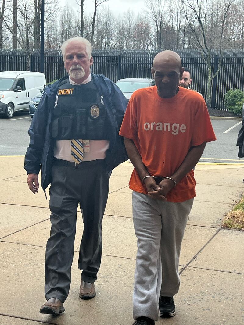 Detective D.K. Wood with Elroy Harrison in custody